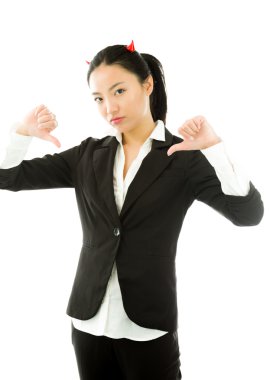Devil side of a young Asian businesswoman showing thumbs down sign with both hands isolated on white background