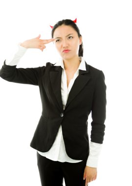 Devil side of a young Asian businesswoman shooting herself in head isolated on white background