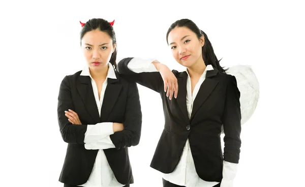 Angel and devil sides of a young Asian businesswoman isolated on white background — Stock Photo, Image