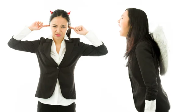 Angel side of a young Asian businesswoman shouting over devil side isolated on white background — Stockfoto