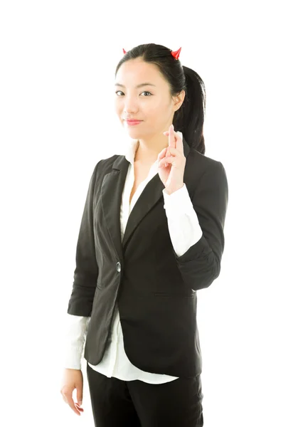 Devil side of a young Asian businesswoman standing with her fingers crossed isolated on white background — Stock Photo, Image