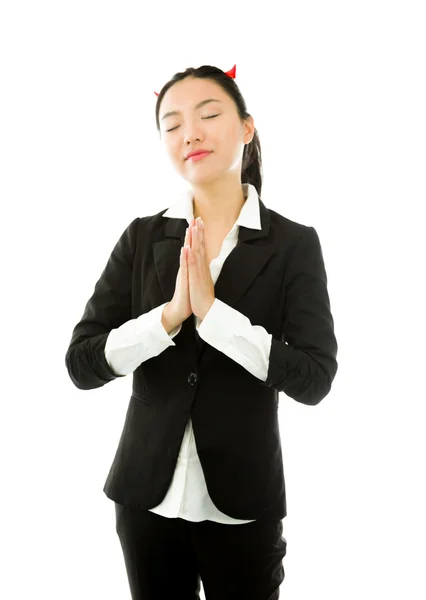 Devil side of a young Asian businesswoman in prayer position isolated on white background — Stock Photo, Image