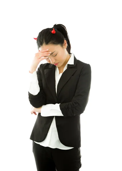 Devil side of a young Asian businesswoman suffering with headache isolated on white background — Stok fotoğraf