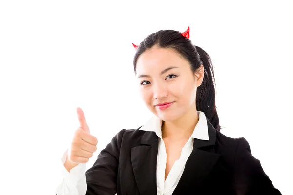 Devil side of a young Asian businesswoman showing thumb up sign and smiling isolated on white background — Zdjęcie stockowe