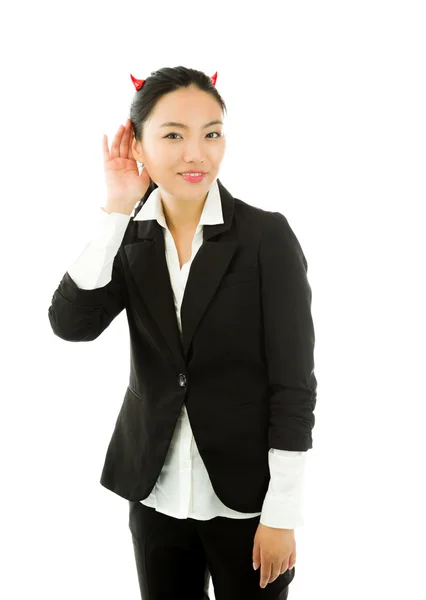 Devil side of a young Asian businesswoman trying to listen isolated on white background Stok Resim