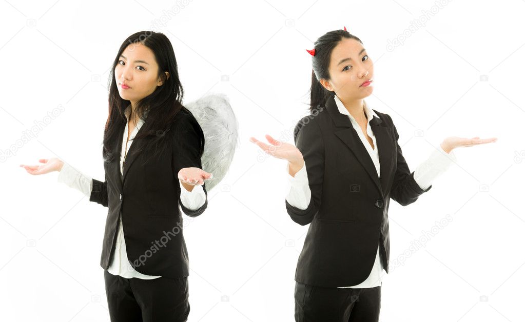 Angel side and devil side of a young Asian businesswoman shrugging and standing back to back isolated on white background