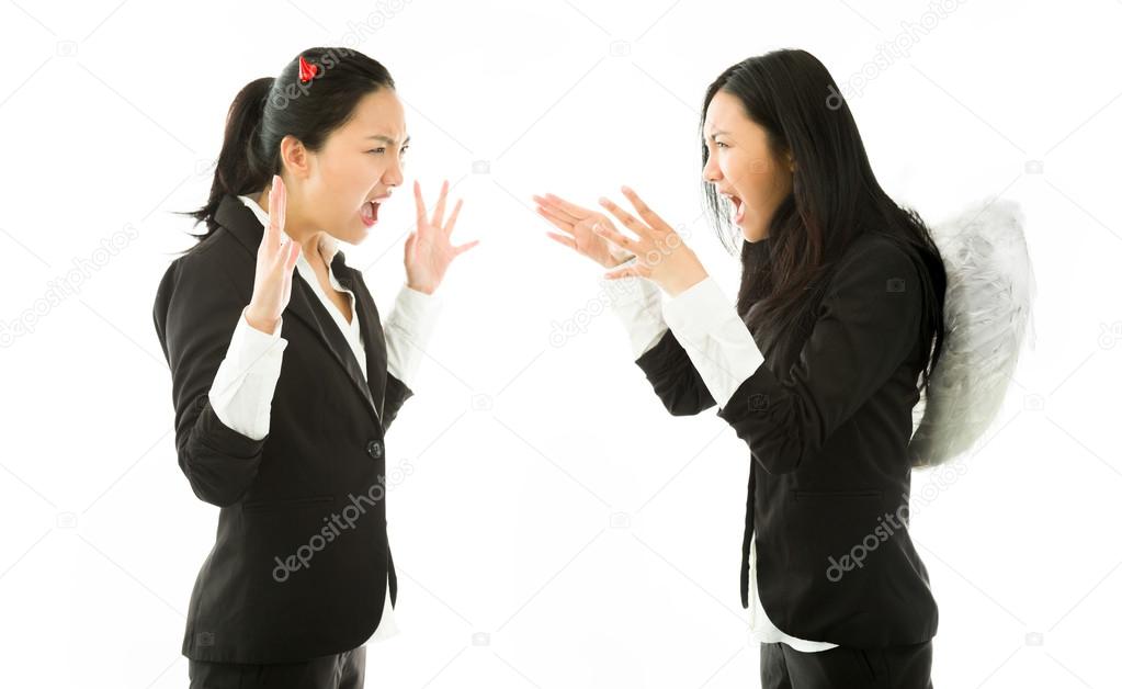 Devil and angel sides of a young Asian businesswoman strangling each other isolated on white background