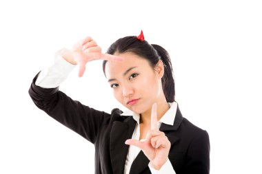 Devil side of a young Asian businesswoman making frame with fingers isolated on white background