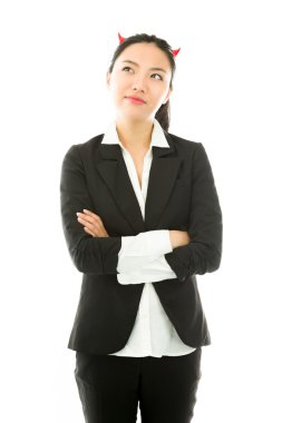 Devil side of a young Asian businesswoman standing with arms crossed and day dreaming isolated on white background