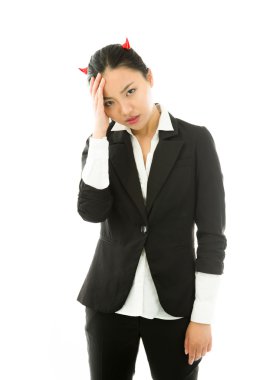 Devil side of a young Asian businesswoman suffering with headache isolated on white background