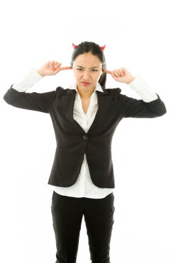 Devil side of a young Asian businesswoman standing with fingers in ears and looking frustrated isolated on white background