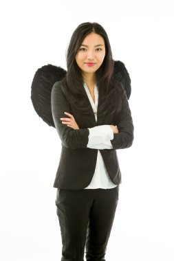Asian young businesswoman dressed up as black angel standing with arms crossed