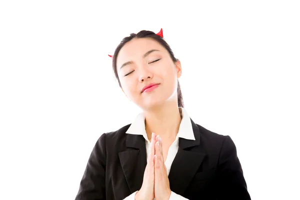 Devil side of a young Asian businesswoman in prayer position isolated on white background — ストック写真