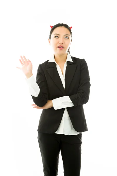 Lado diabólico de una joven empresaria asiática haciendo gestos e ignorando aislada sobre fondo blanco — Foto de Stock