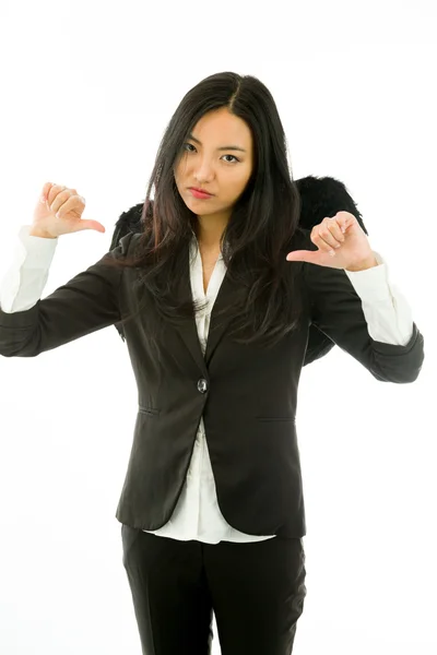 Disappointed Asian young businesswoman dressed up as black angel thumbs down isolated on white background — Stockfoto