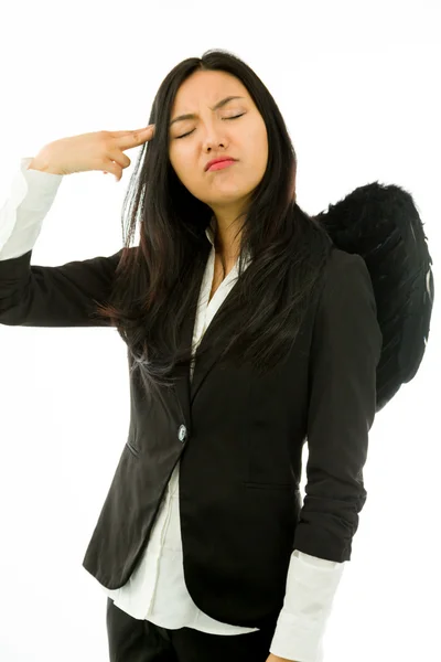 Asian young businesswoman dressed up as black angel pointing finger to head isolated on white background — Zdjęcie stockowe