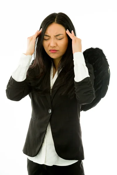 Stressed Asian young businesswoman dressed up as black angel suffering from headache isolated on white background — ストック写真