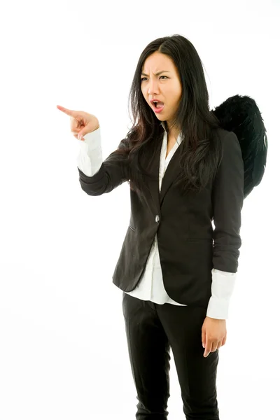 Irritado ásia jovem empresária vestido até como preto anjo repreendendo alguém isolado no branco fundo — Fotografia de Stock