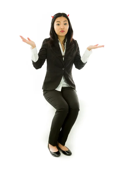 Asian young businesswoman sitting on stool in devil horns dont know what to do isolated on white background — ストック写真