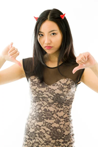 Asian young woman dressed up as a devil  and showing thumbs down sign from both hands isolated on white background — Stockfoto