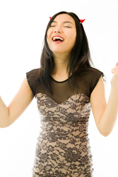 Asiático jovem mulher vestida como um diabo comemorando seu sucesso com punho até isolado no fundo branco — Fotografia de Stock