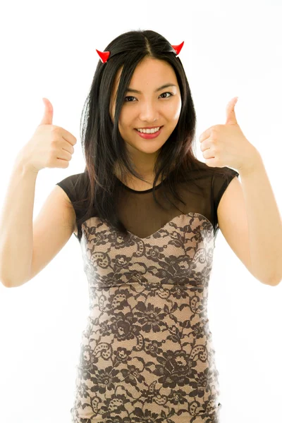 Ásia jovem mulher vestido até como um diabo com mostrando polegar para cima sinal com ambas as mãos isolado no branco fundo — Fotografia de Stock