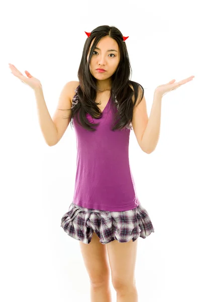 Asian young woman dressed up as a devil  with shrugging expression isolated on white background — Zdjęcie stockowe