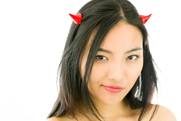 Devil side of a young naked Asian woman smirking — Stockfoto