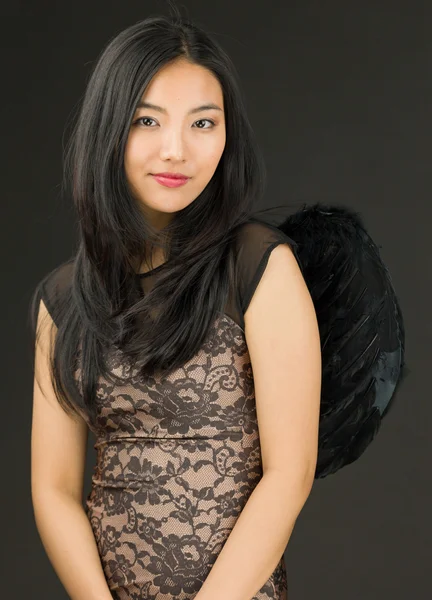 Portrait of an Asian young woman dressed up as a black angel — Stock Photo, Image