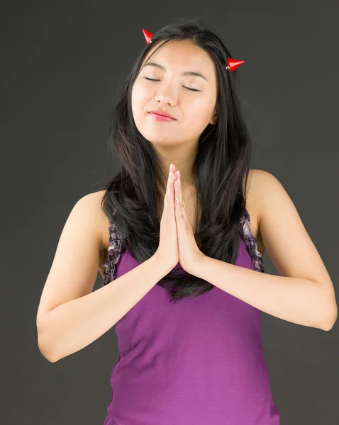 Devil side of a young Asian woman standing in prayer position — Stock Photo, Image