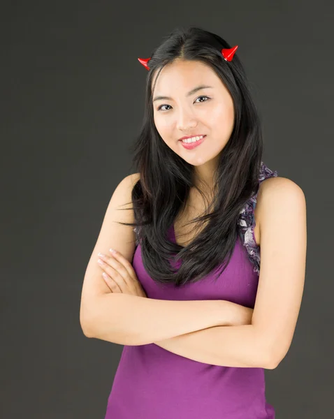 Devil side of a young Asian woman standing with her arms crossed — Stock Photo, Image