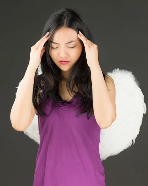 Angel side of a young Asian woman suffering with headache and looking depressed — Stock Photo, Image