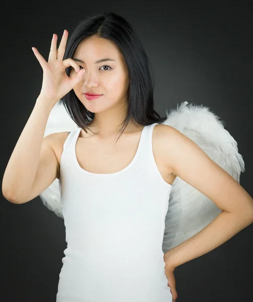 Asiatique jeune femme habillé comme un ange avec montrant OK signe et la main sur la hanche — Photo