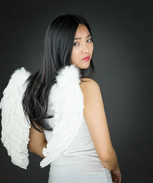 Rear view of a Upset Asian young woman dressed up as an angel turning back — Stock Photo, Image