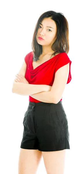 Young woman standing with her arms crossed and looking sad — Stock Photo, Image
