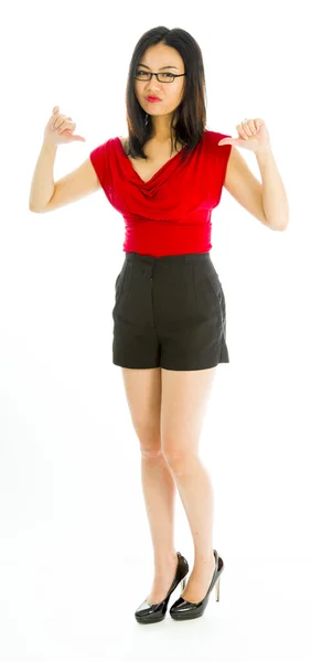 Young woman standing and showing thumbs down sign — Stock Photo, Image