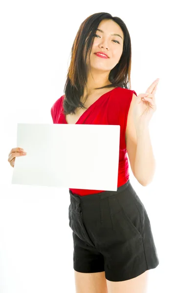 Saleswoman holding a blank placard with her fingers crossed — Stock Photo, Image