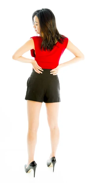 Rear view of a young woman standing with her arms akimbo — Stock Photo, Image