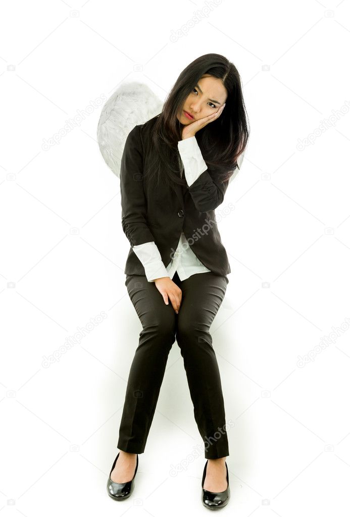 Asian young businesswoman sitting on stool dressed up as an angel looking bored isolated on white background