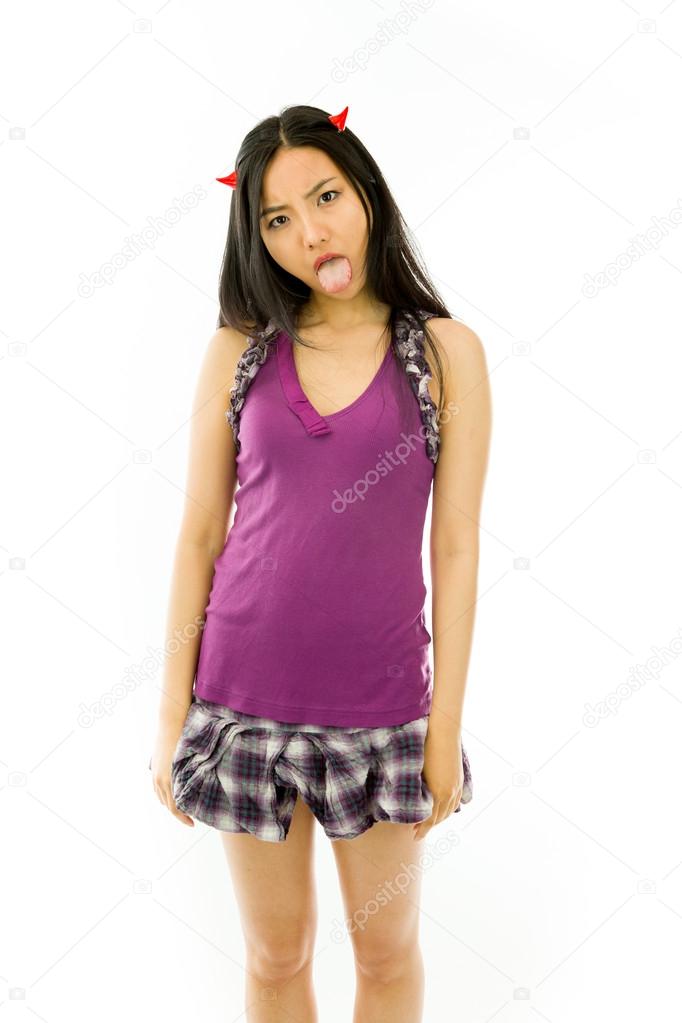 Asian young woman dressed up as a devil  and sticking out her tongue isolated on white background