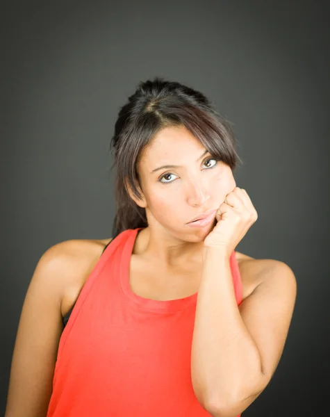 Upset young woman with her hands on cheek — Stock Photo, Image