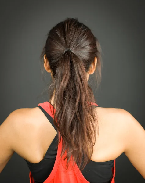 Rear view of a young woman with ponytail — Stock Photo, Image