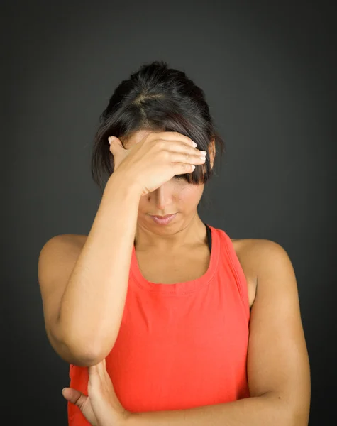Upset young woman with her head in hands — Stock Photo, Image
