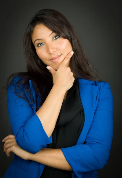 Confident young businesswoman with her hand on chin — Stock Photo, Image