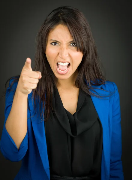 Angry young businesswoman scolding somebody — Stock Photo, Image