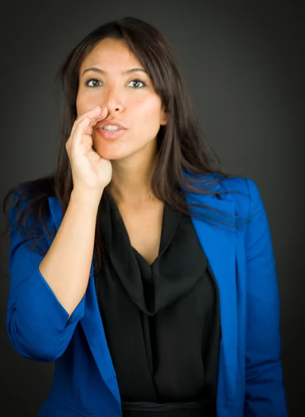 Young businesswoman whispering message with cupping hands over mouth — Stock Photo, Image