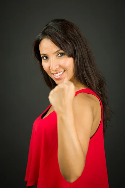 Young woman showing her fist and celebrating her success — Stock Photo, Image