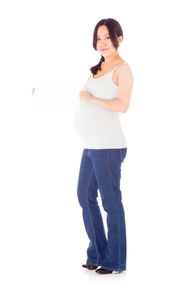 Pregnant woman holding blank sign — Stock Photo, Image