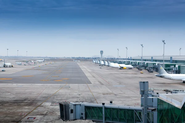 Airplanes parked at the terminal of an airport — Stock Photo, Image