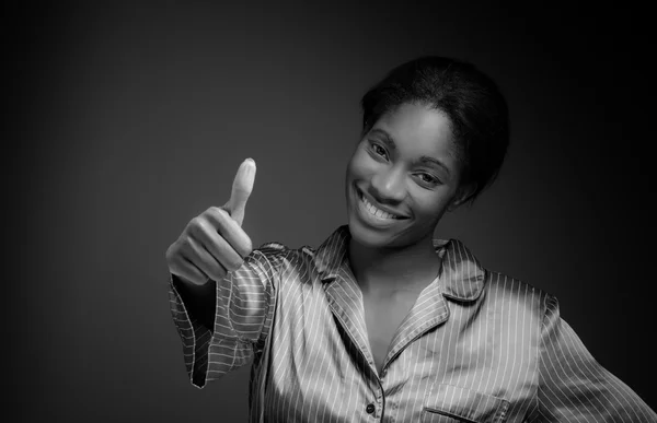 Model gesturing thumb up sign — Stock Photo, Image